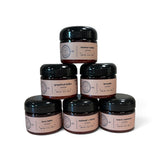 Lotions arranged in a pyramid with scents of coconut cream, grapefruit bellini, lavender, love letter, oatmeal + honey and warm cashmere