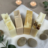 4 bars of soap on a towel with a spa scene